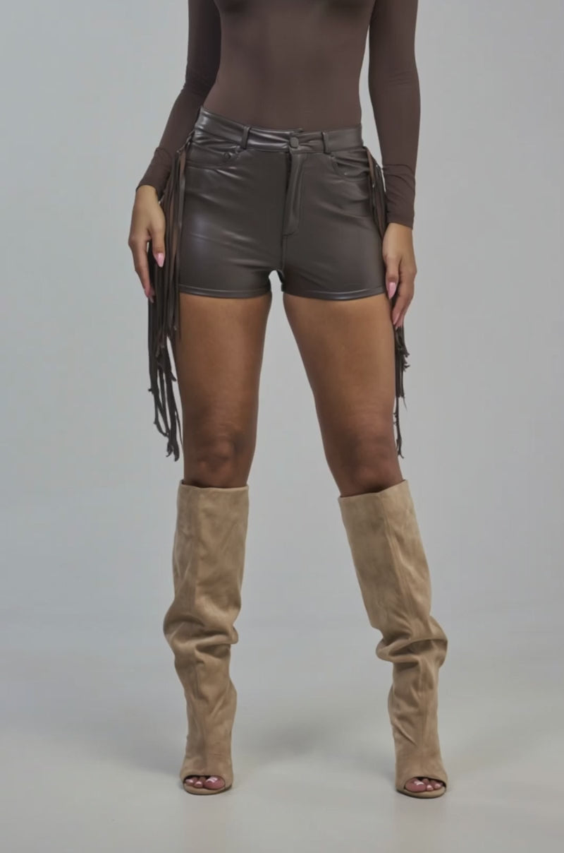 Video of a woman modeling the RODEO CHIC FAUX LEATHER SHORT.