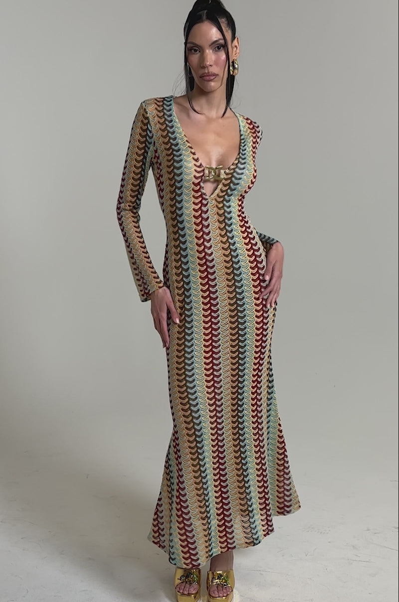 A video of a woman in the THREAD THEORY CROCHET MAXI DRESS, a long-sleeve, multicolor knit maxi with a deep V-neckline. 