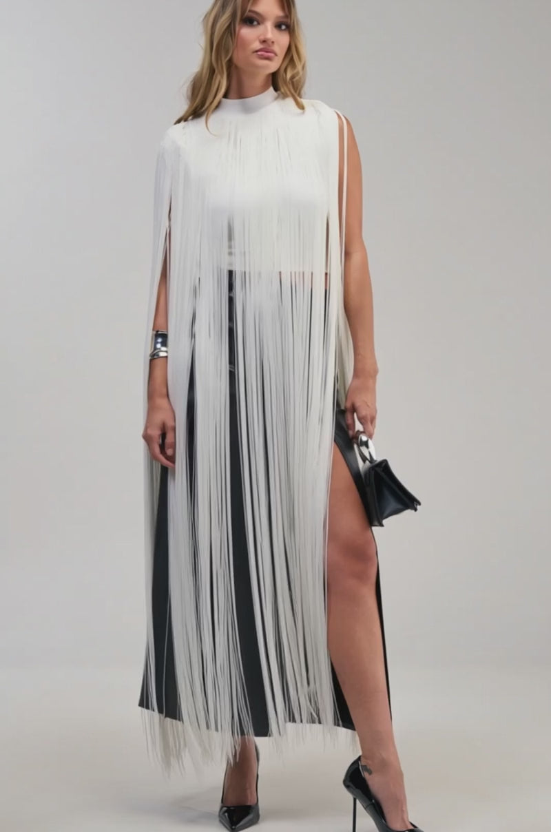 Video of a woman modeling the FLY AWAY FRINGE TOP, a fringe crop top with long white fringe.
