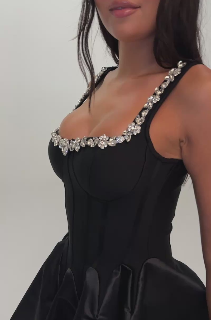Video of a woman modeling the SHIMMER FRAME RHINESTONE MINI DRESS IN BLACK, a woman dazzles in jewel-embellished sophistication.