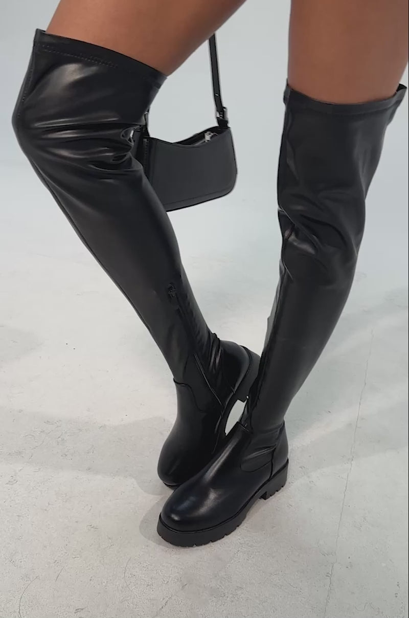 Video of woman modeling the AZALEA WANG SECURITY FLAT BOOT and a black mini skir