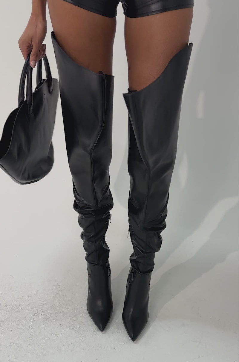 Video of woman modeling the AKIRA GOLD CHROMEA BLACK THIGH HIGH STILETTO BOOTS with sculptural flared tops.