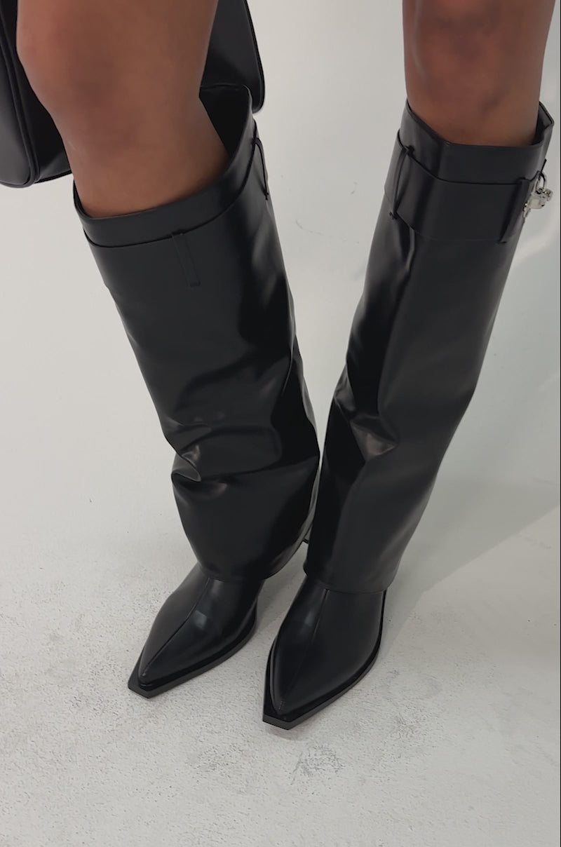 Video of woman modeling the AZALEA WANG CHRONO BLACK METAL HEEL BOOT—pointed toe, knee-high with silver accents