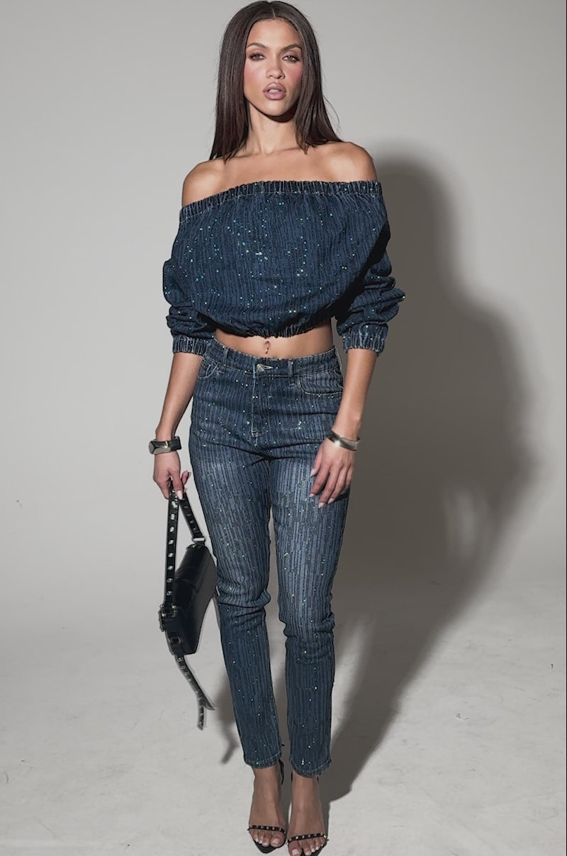 Video of woman modeling the SHINING STAR OFF THE SHOULDER RHINESTONE DENIM SWEATSHIRT and matching pants
