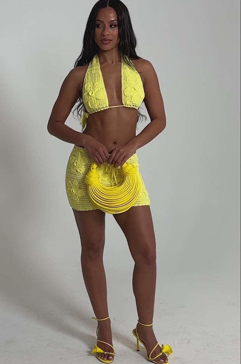 Video of woman modeling the LETS GO TO THE BEACH BRALETTE and matching yellow skirt—an ideal pick for stylish beachwear.