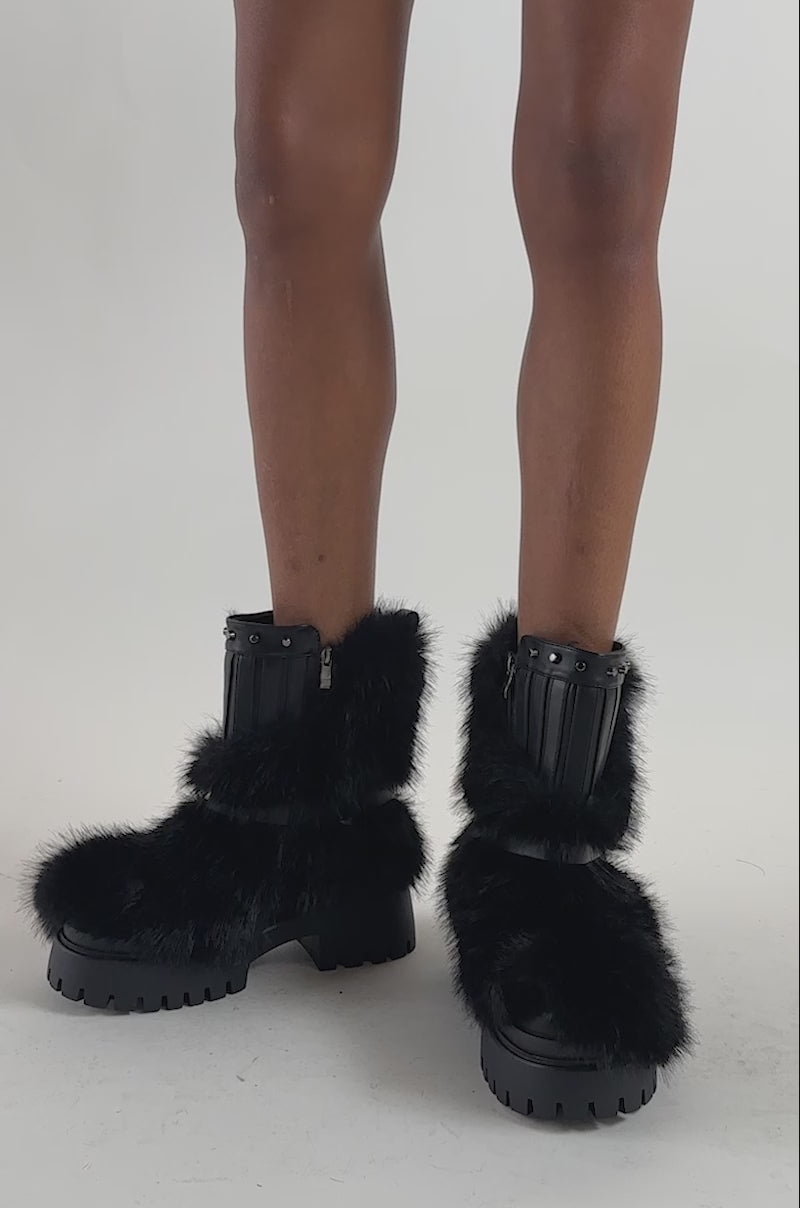 Video of a woman modeling the AZALEA WANG ZAYDEN BLACK FUR FLAT BOOTIE.