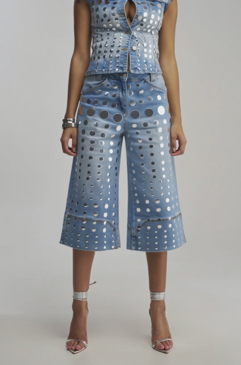 Video of woman modeling the STUDS EVERYWHERE CULOTTE paired with silver high heels, standing against a plain background.