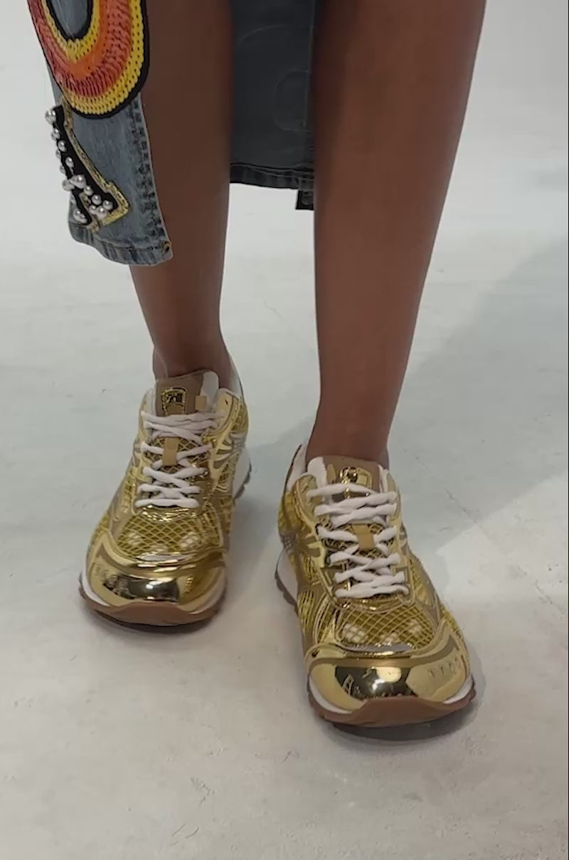 Video of woman modeling the AKIRA GOLD LENIYA GOLD SNEAKER with white laces