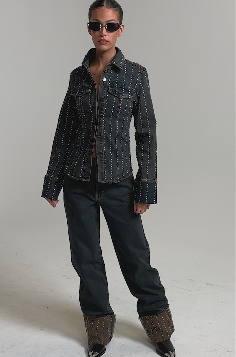 Video of woman modeling the VANJA STUDDED WIDE LEG DENIM jeans, and pointed shoes against a plain light background.