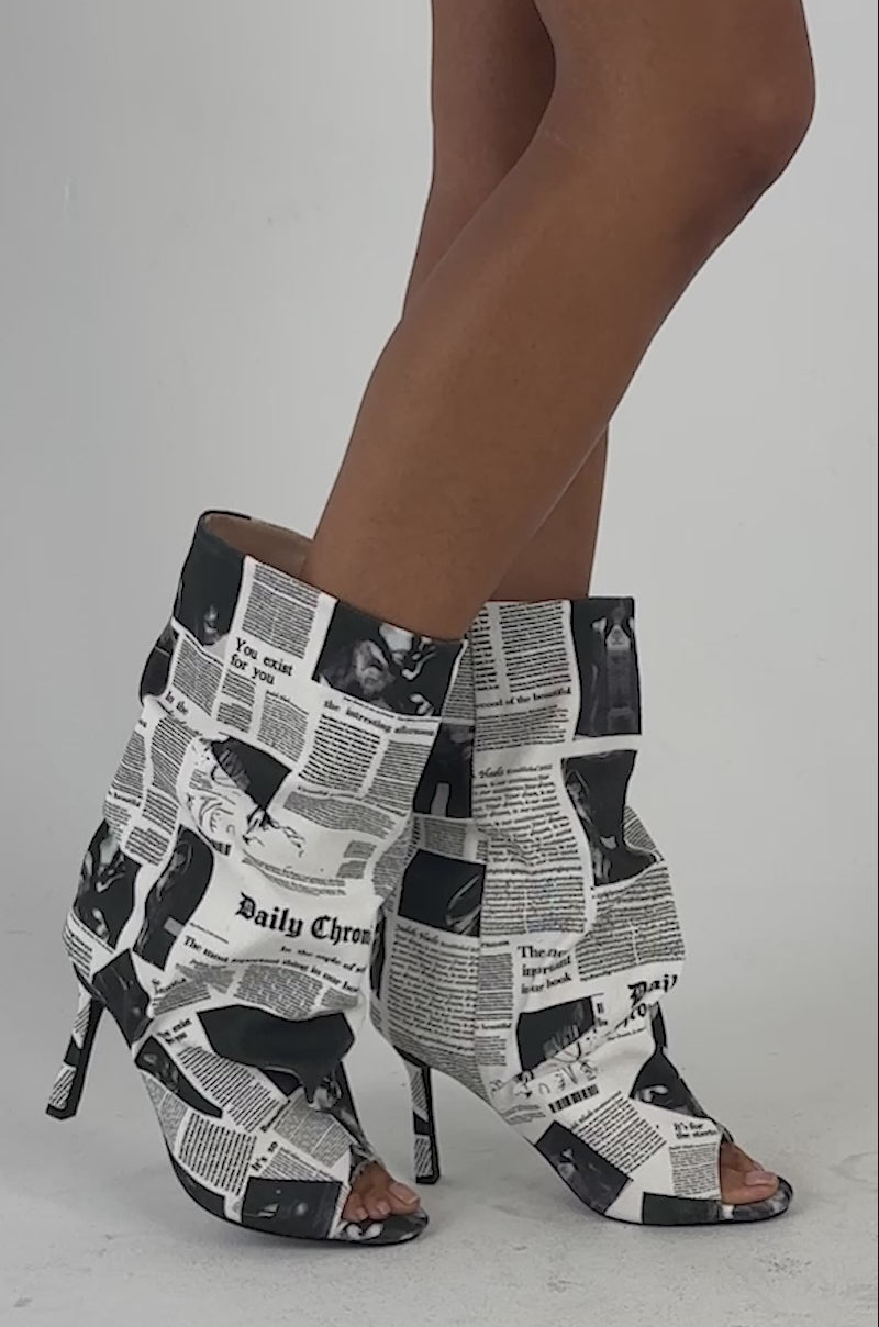 Video of a woman modeling the AKIRA SCREENKISS NEWSPAPER PRINT STILETTO BOOTIE.