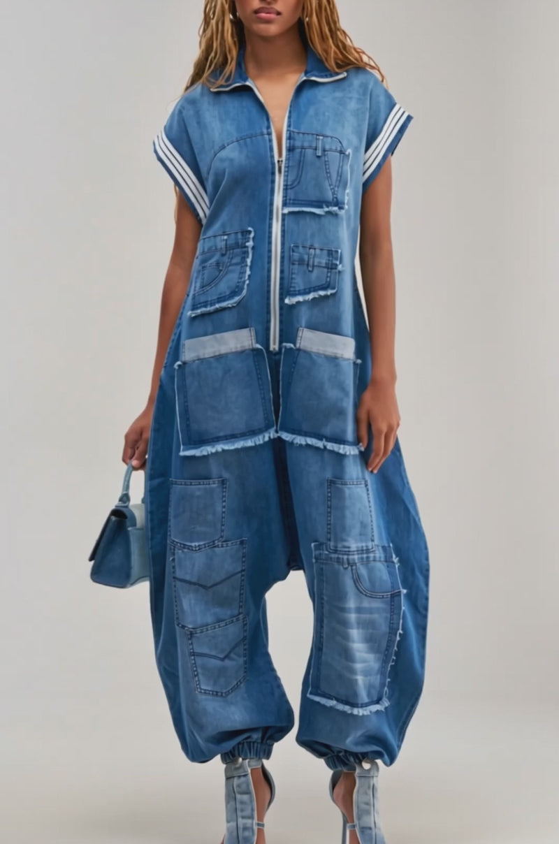 Video of a woman modeling the OFF-DUTY DENIM PATCHWORK JUMPSUIT—featuring a loose silhouette, multiple pockets, patchwork details, cuffed ankles.