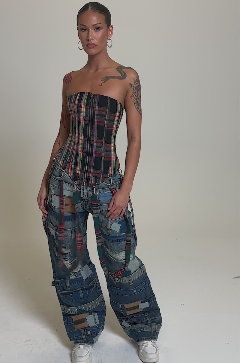 Video of woman modeling the COOL ENOUGH RELAXED DENIM wide-leg patchwork jeans in mixed blue shades with seams and distressed details, styled with white sneakers and a fitted plaid top.