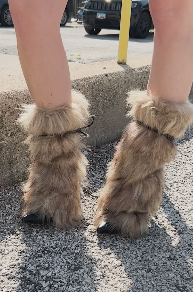Video of person showing off the AZALEA WANG MAHTAMA BLACK FUR EMBELLISHED BOOTIE, a black stiletto heel shoe with light brown fur and a faux leather strap