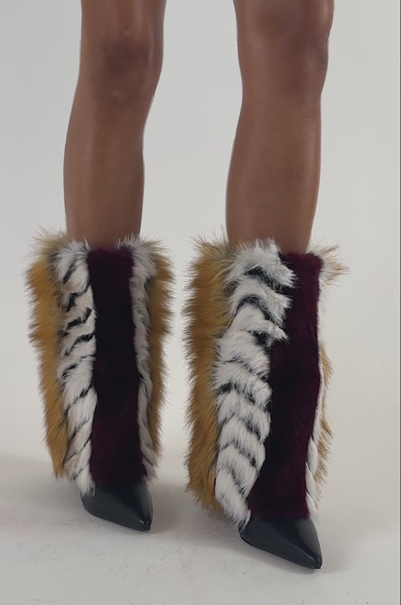 Video of a woman modeling the BURGUNDY MULTI FUR WEDGE BOOTIE.