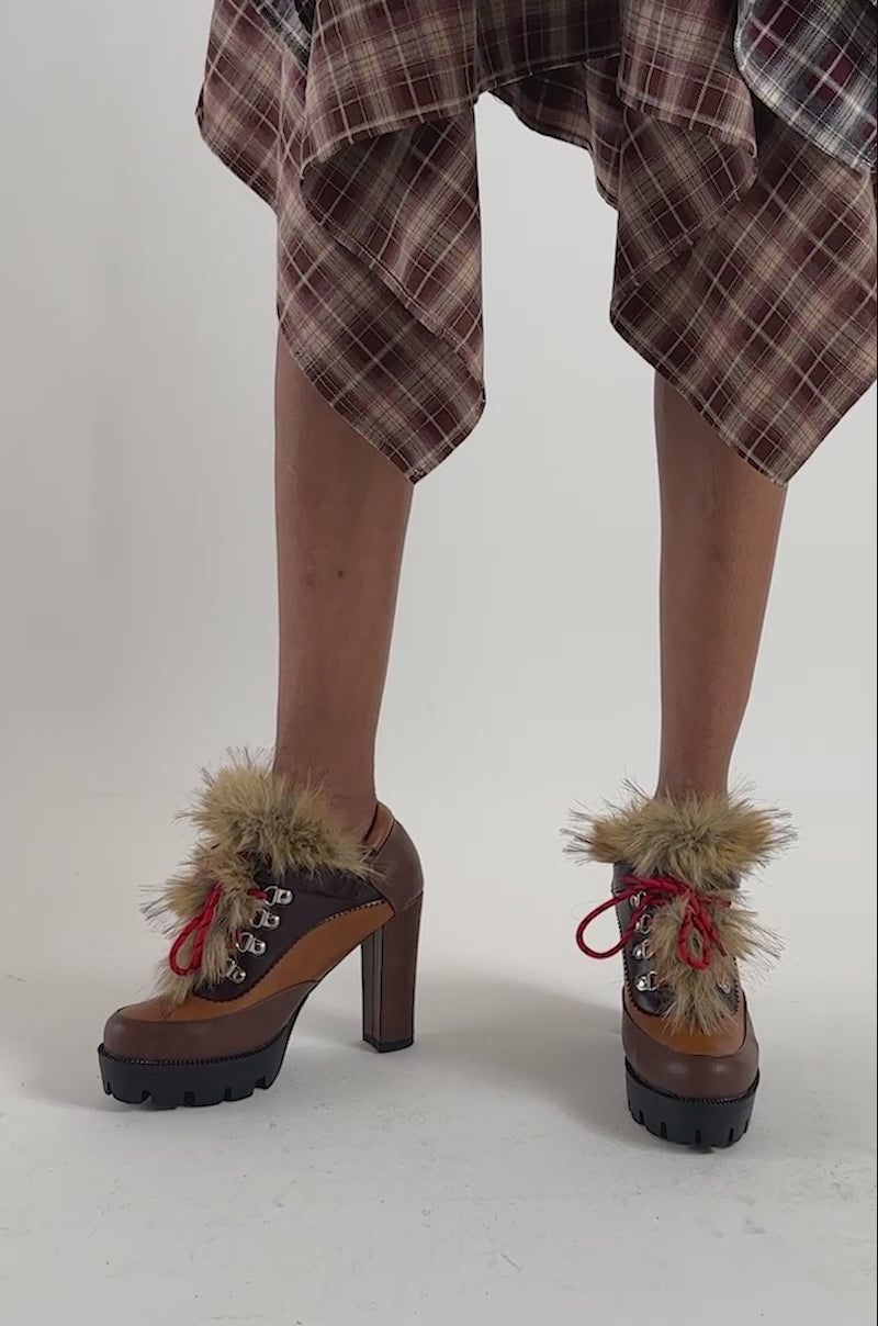 Video of a woman modeling the AZALEA WANG HORIZON BROWN PLATFORM ANKLE BOOTIE with a chunky block heel.