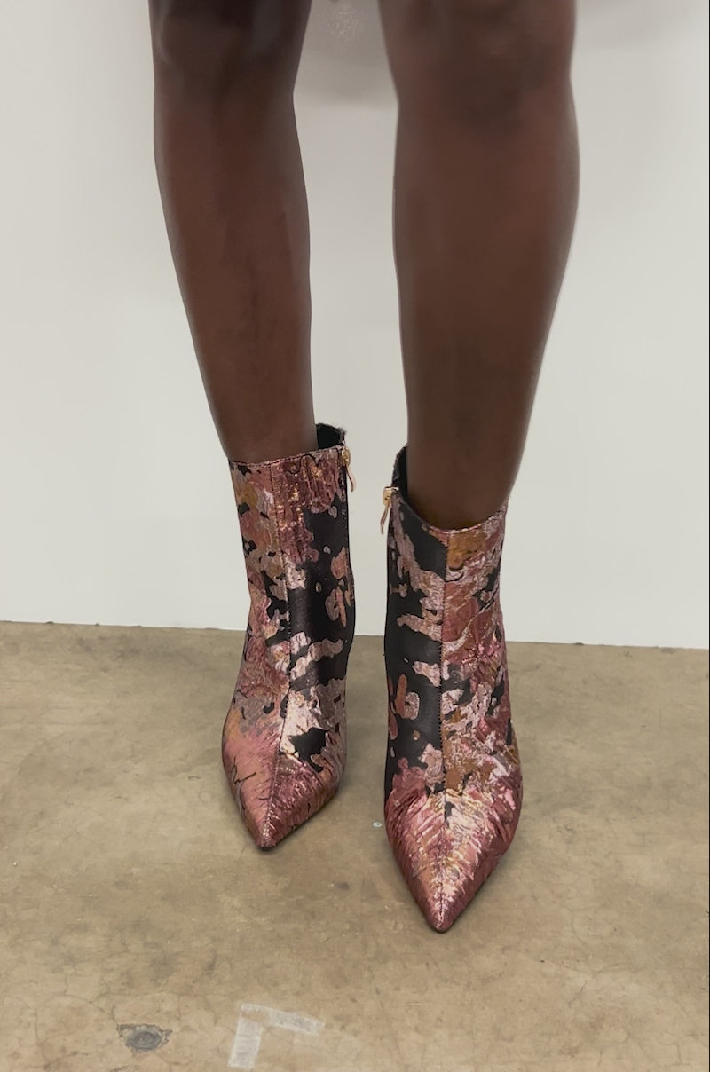 Video of woman modeling the AZALEA WANG FARID BLACK MULTI CHUNKY BROCADE BOOTIE, featuring metallic floral patterns and a sculptural chunky heel.