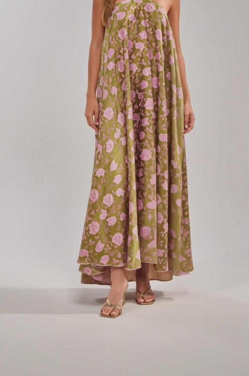 Video of woman modeling the MIDNIGHT GARDEN FLORAL MAXI DRESS—a floor-length green satin dress with a pink floral pattern