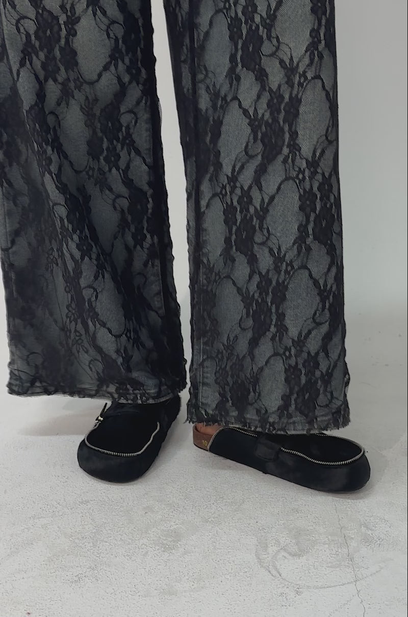 A video of a person wearing snake-print pants and AZALEA WANG LIMERICK BLACK METAL EMBELLISHMENT FLAT mules.