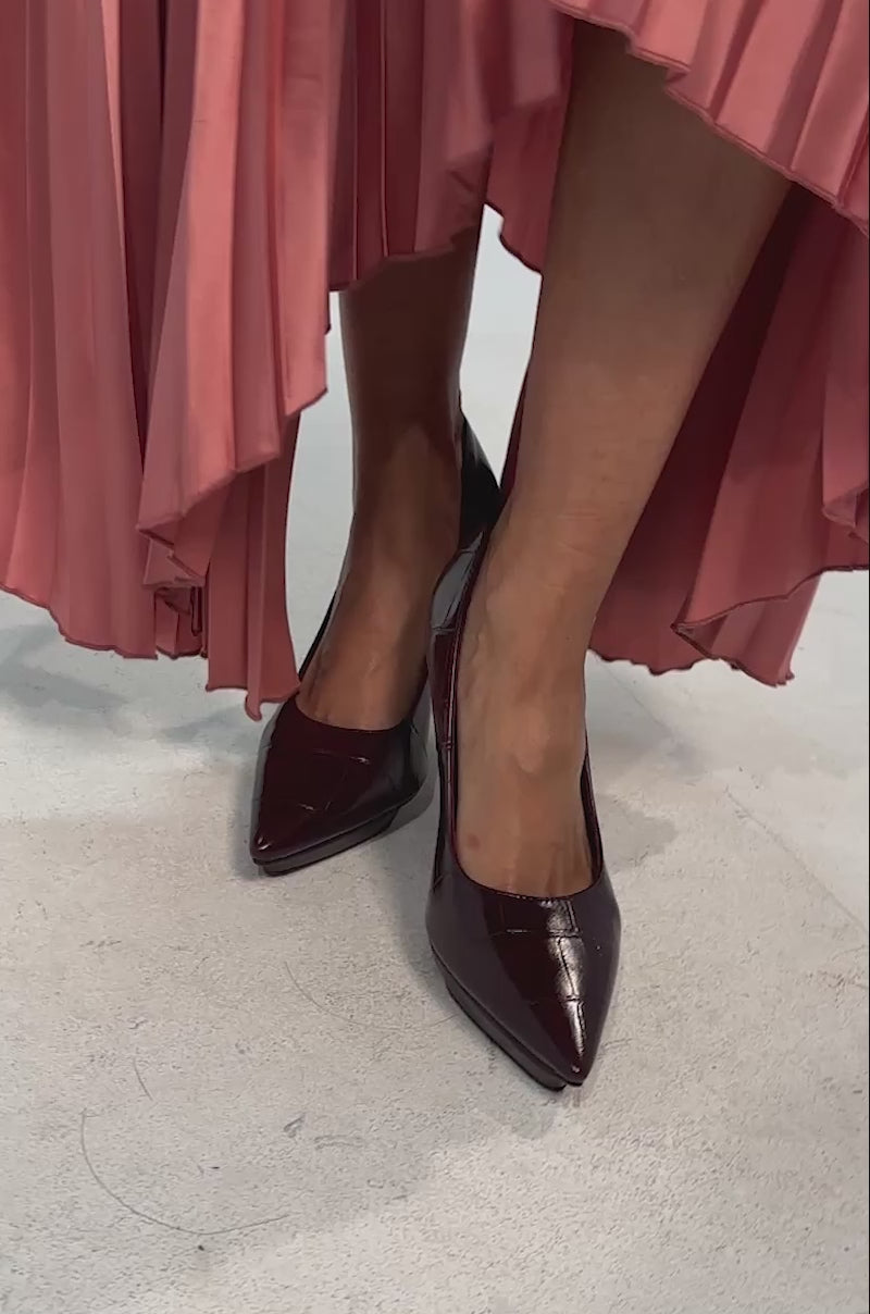 Video of woman modeling the AKIRA GOLD SKYSCRAPER BURGUNDY PLATFORM STILETTO PUMPS against a plain light background.