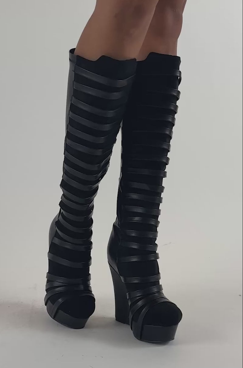 Video of a woman modeling the AZALEA WANG KAEL BLACK STRAPPY WEDGE BOOTS.
