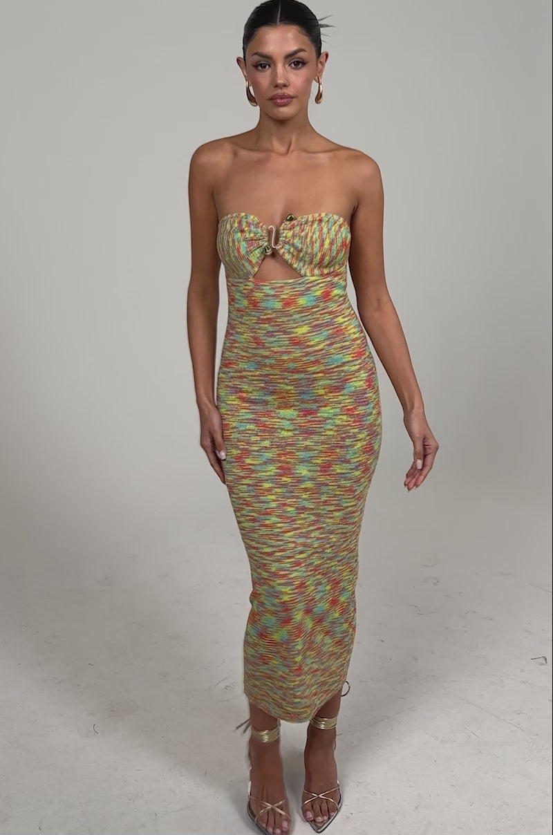 Video of woman modeling the STARRY NIGHT KNIT MIDI DRESS IN MULTI, featuring a multicolor textured knit and strapless midi silhouette. She completes her look with slicked-back hair, hoop earrings, and strappy heels against a plain background.