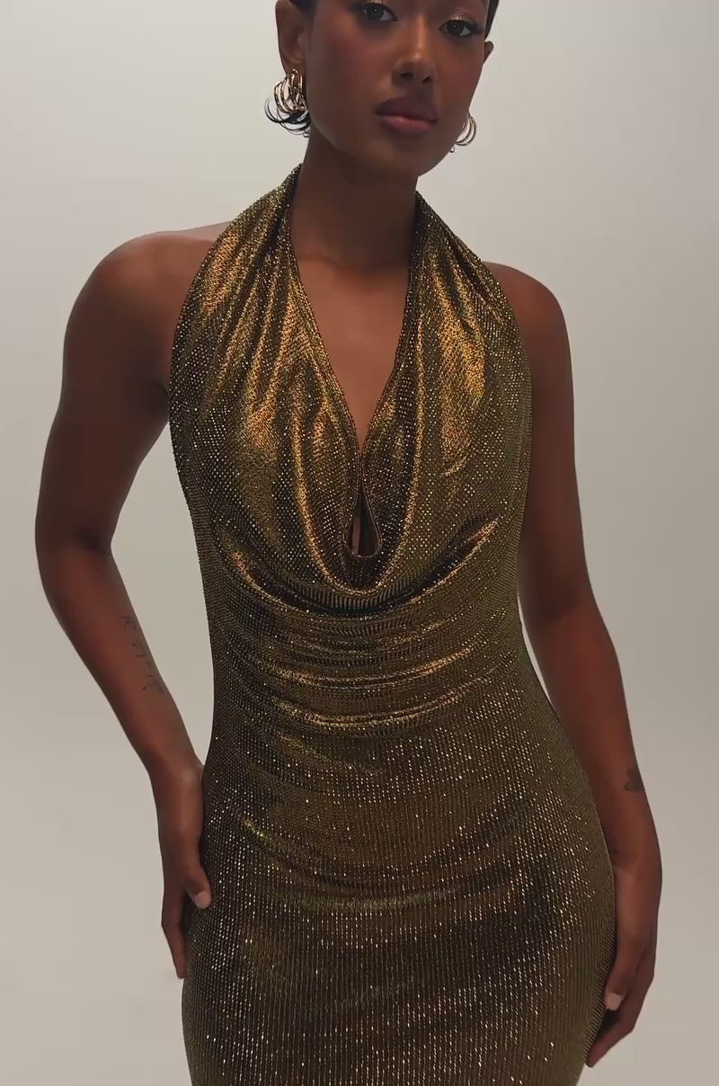 Video of a woman modeling the POPPIN’ BOTTLES RHINESTONE MAXI DRESS IN GOLD—a sleeveless, gold metallic halter party dress.