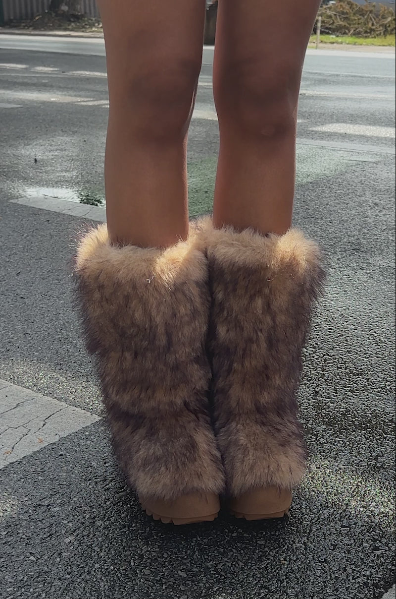 A video of a person wearing the AZALEA WANG LEOPOLD BROWN MULTI FLAT FUR BOOT featuring a faux fur design and platform lug sole.