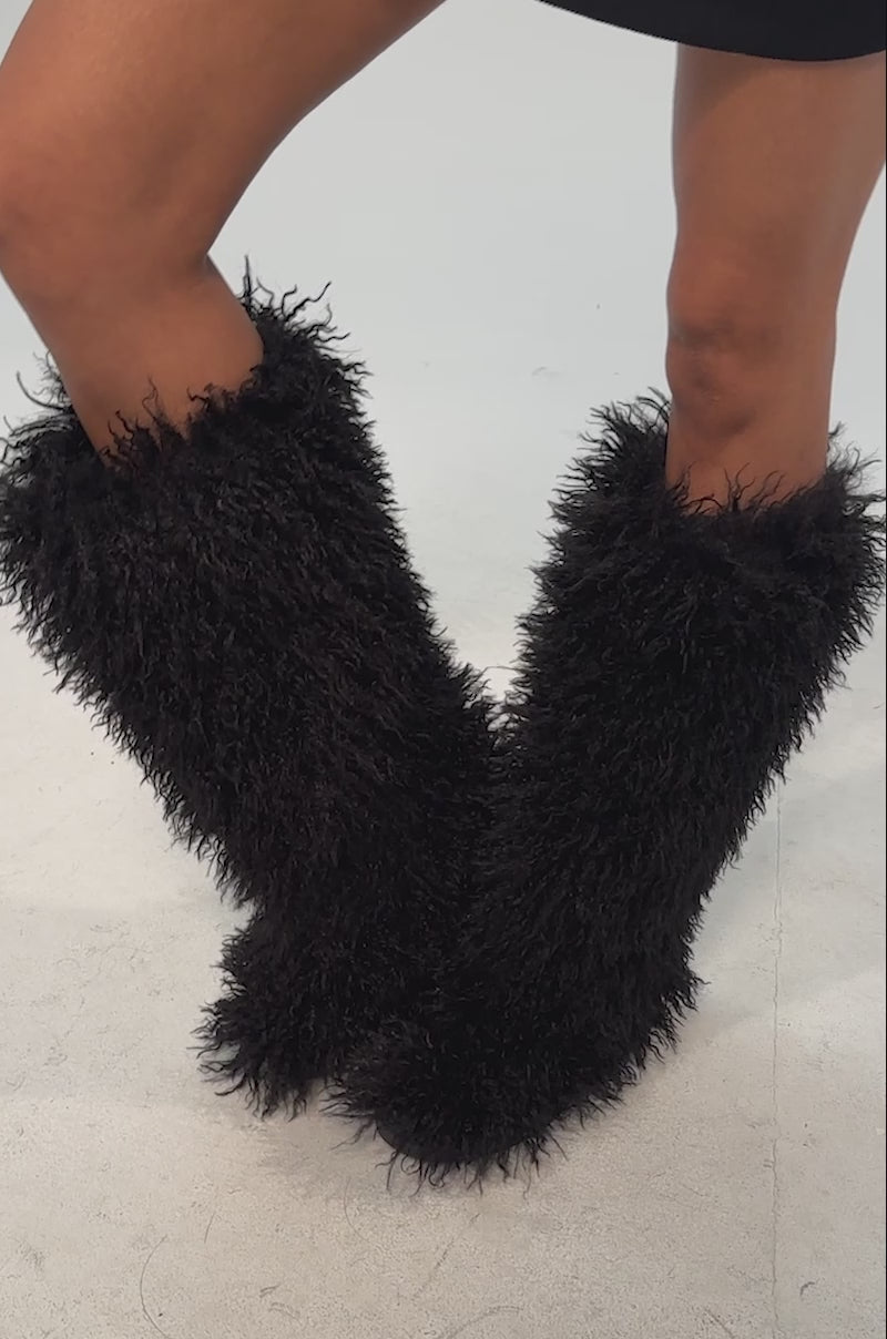 Video of woman modeling the AZALEA WANG DENTON BLACK KNEE HIGH FLAT FUR BOOT against a plain light background.