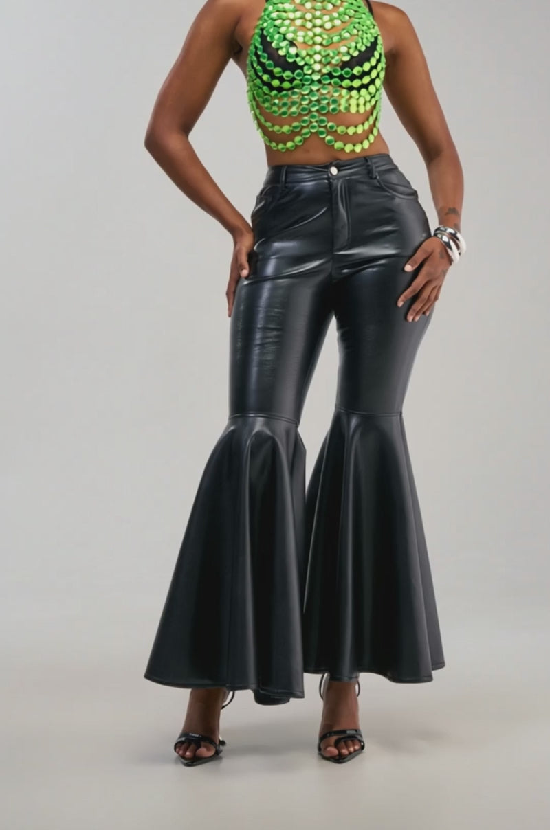 Video of a woman modeling the FLY AWAY WITH ME FAUX LEATHER FLARE TROUSER, featuring a flattering high-rise fit.