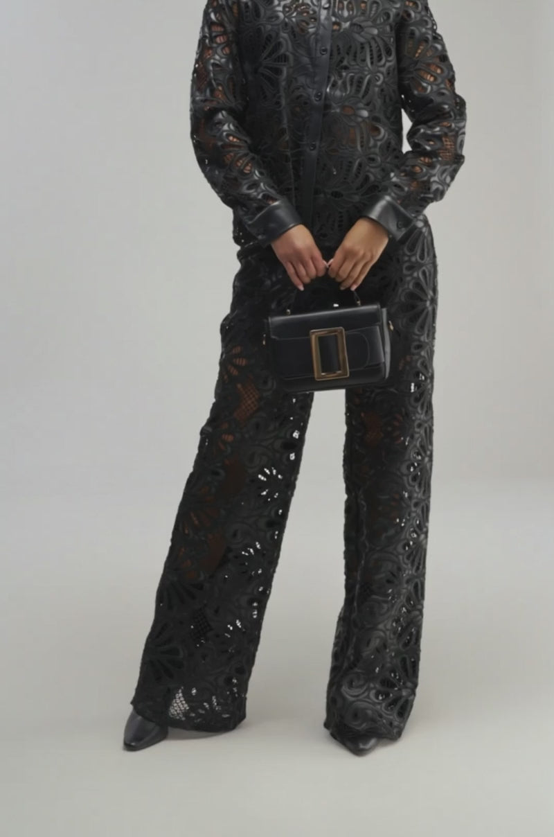 Video of a woman modeling the LUCKY ME LONG SLEEVE BUTTON DOWN—a black, patterned leather jacket with faux leather trim.