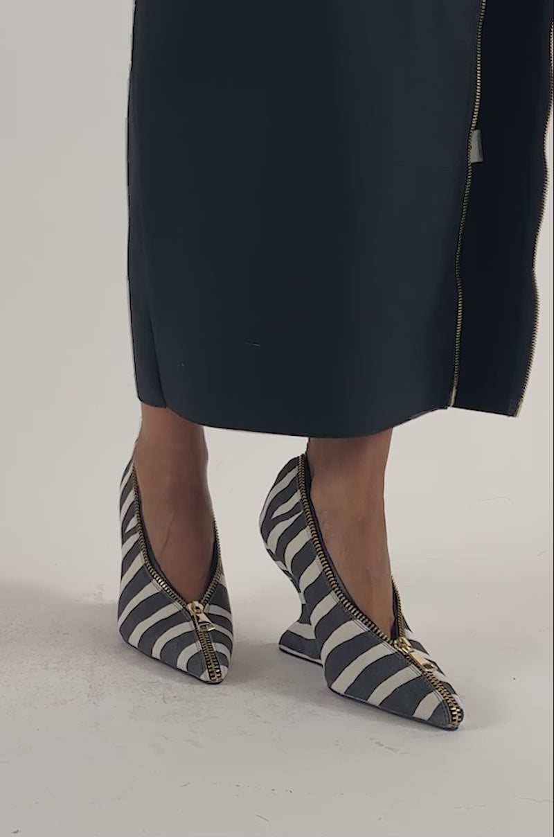 Video of a woman modeling the AZALEA WANG GIAVANNA MULTI WEDGE STRIPED PUMP, which features black-and-white stripes, visible gold zippers, and a comfort cushion insole.