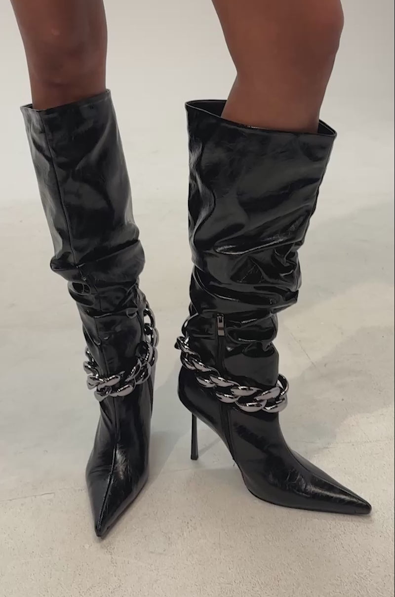 Video of woman modeling the AKIRA GOLD AFTERHOURS BLACK STILETO BOOT WITH METAL DETAIL