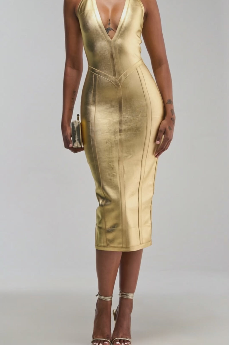 Video of a woman modeling the TIA BANDAGE MIDI DRESS IN GOLD METALLIC, a form-fitting design with a deep neckline. 