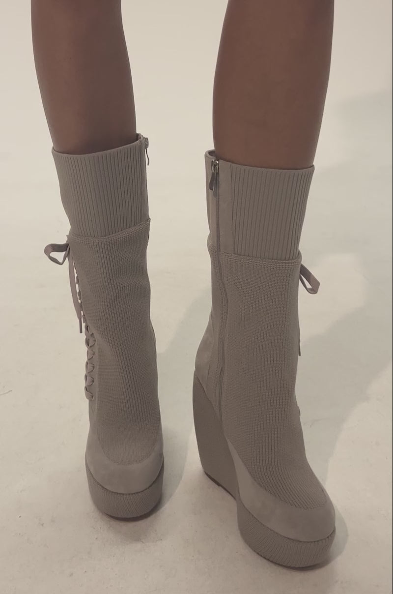 Video of woman modeling the the AKIRA GOLD WHATEVER WARM GREY CANVAS WEDGE BOOTIE, featuring grey laces, ribbed texture, and a side zipper—ideal cold weather boots for a chic and cozy look.