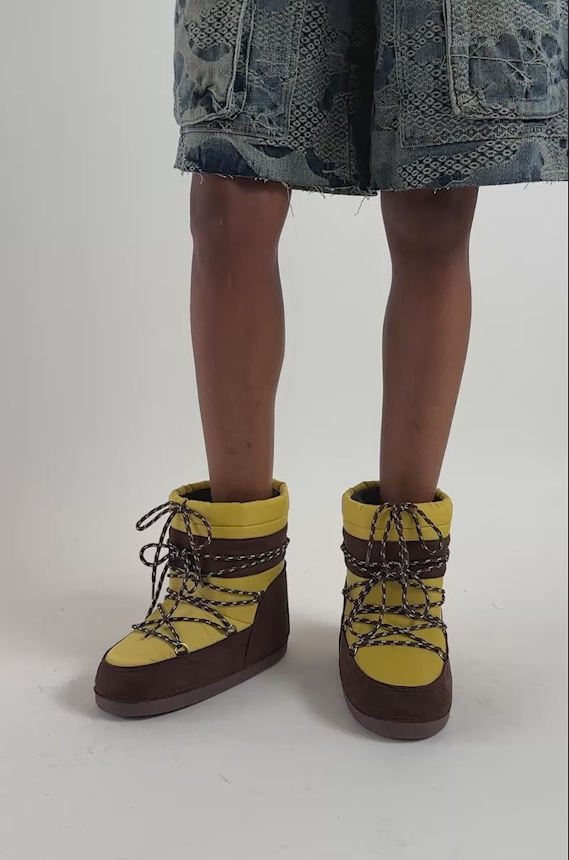 Video of a woman modeling the AZALEA WANG GRAVITY YELLOW MULTI FLAT BOOTIE.