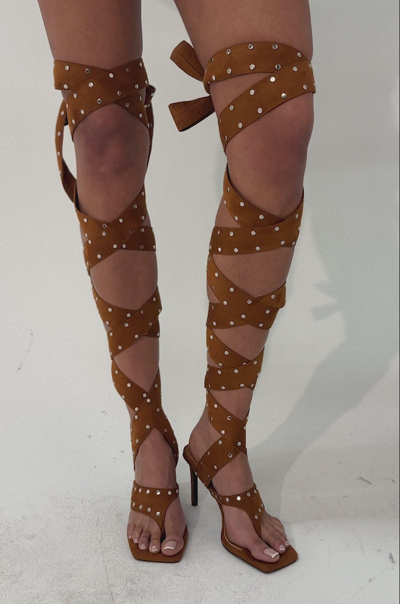 A video of a person where the AZALEA WANG SODALITE COGNAC strappy faux suede sandals.