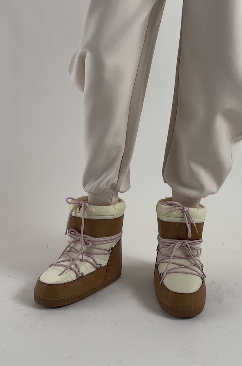 Video of a woman modeling the AZALEA WANG GRAVITY TAN MULTI FLAT BOOTIE—with its tan faux leather, pink and white laces. 