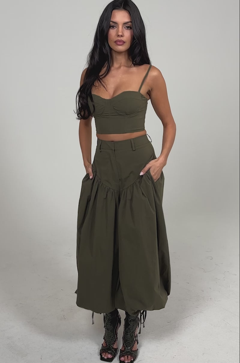 Video of woman modeling the LUCKY FOR YOU BALLOON PANT, styled with lace-up peep-toe boots. She stands confidently against a plain, light background.