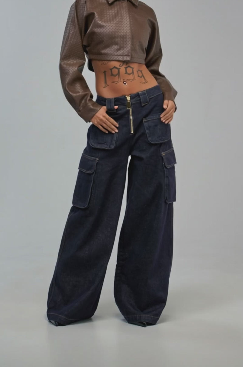 Video of a woman modeling the ALL ABOUT THAT DENIM POCKET PANT, styled with wide leg dark wash denim. 