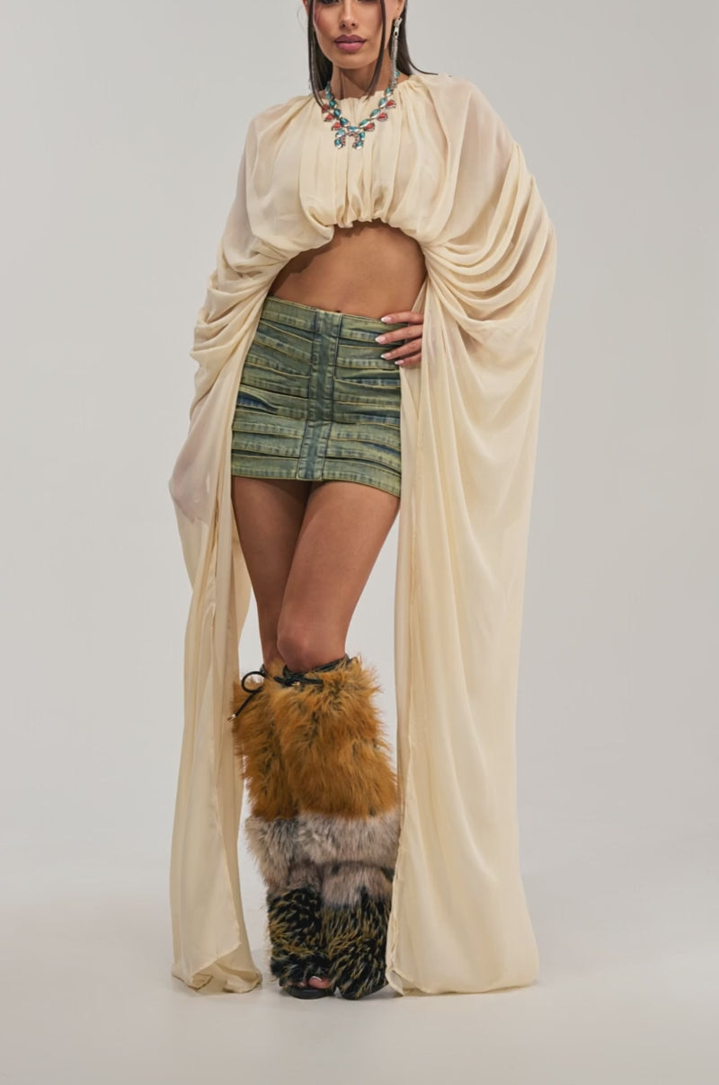 Video of a woman modeling the FLY WITH ME CHIFFON BLOUSE IN IVORY with exaggerated sleeves.