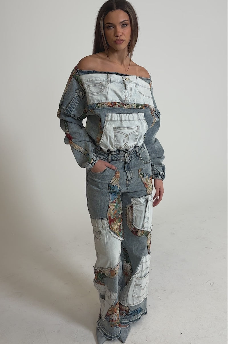 Video of woman modeling the CHANGE IT UP WIDE LEG DENIM—a matching mixed-wash set with white patchwork, floral details, off-the-shoulder long sleeves, and high-rise wide-leg jeans.