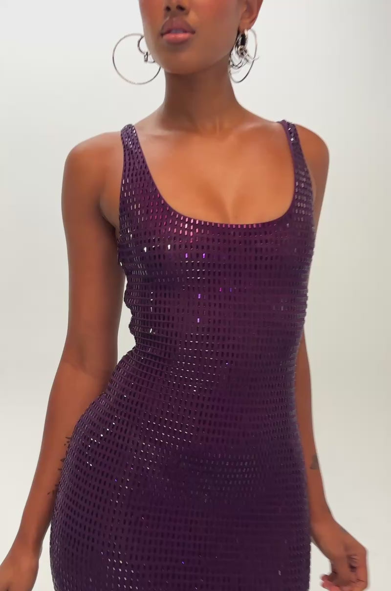 Video of a woman modeling the MY MUSE EMBELLISHED RHINESTONE MIDI DRESS IN AMETHYST, a sleeveless purple mesh midi dress adorned with sparkling rhinestone embellishments.