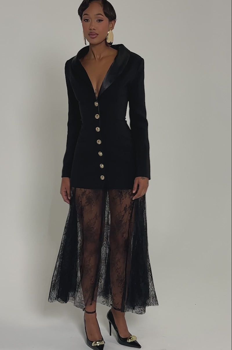 Video of woman modeling the OK BOSS LADY BLAZER MAXI DRESS, featuring black suiting fabric, gold buttons, and a sheer lace skirt
