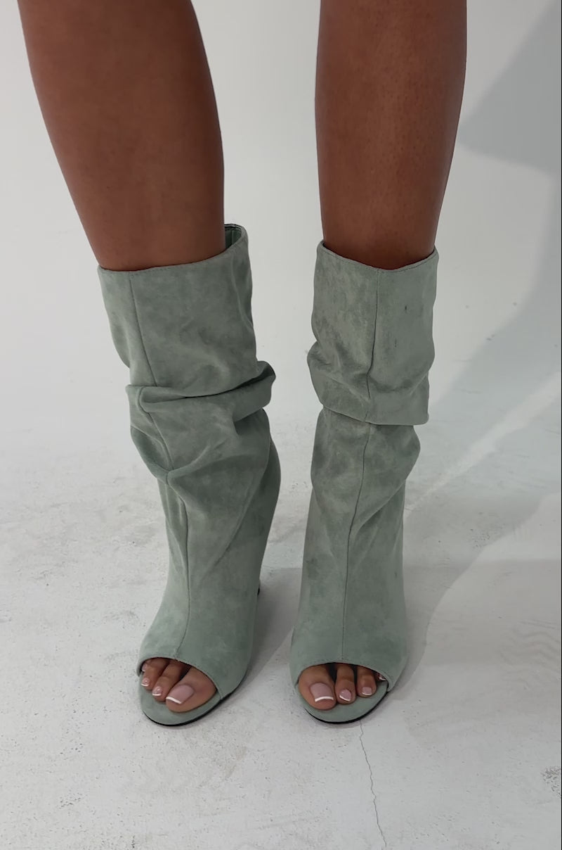 A video of a person wearing the AZALEA WANG MARIN Sage Faux Suede Wedge Bootie against a plain background.