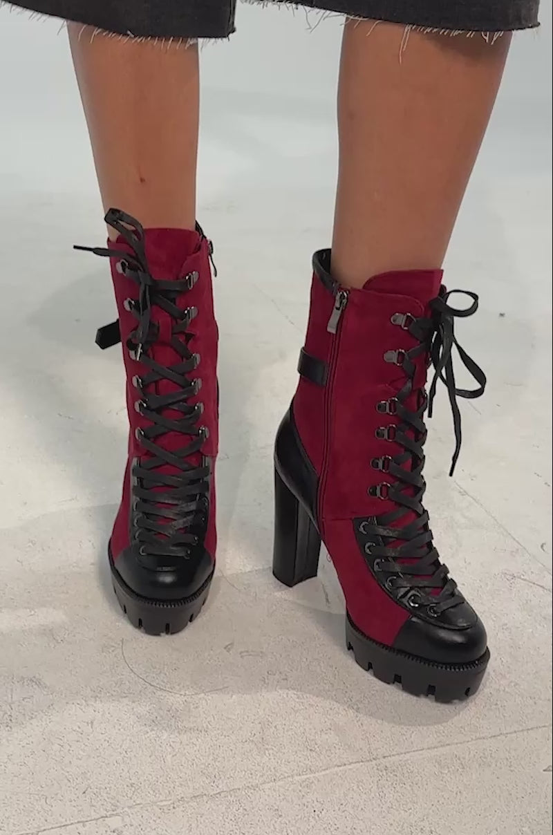 Video of woman modeling the AZALEA WANG BARRINGTON BURGUNDY COLOR BLOCKED SPORTY CHUNKY BOOTIE with platform lug soles, side zippers, bold lace-up detailing, and a rugged stylish design.
