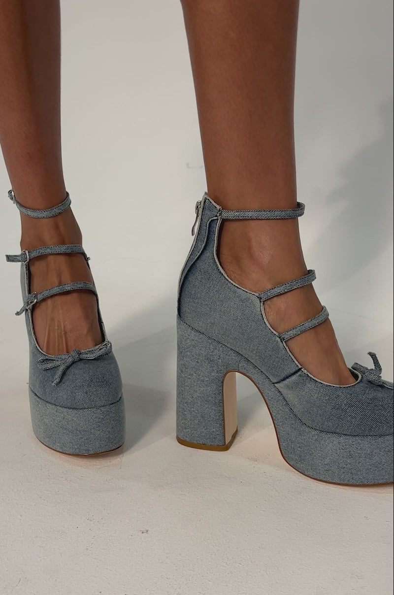 Video of woman modeling the AZALEA WANG SPROUT DENIM CHUNKY PUMP platform block heels with ankle straps.