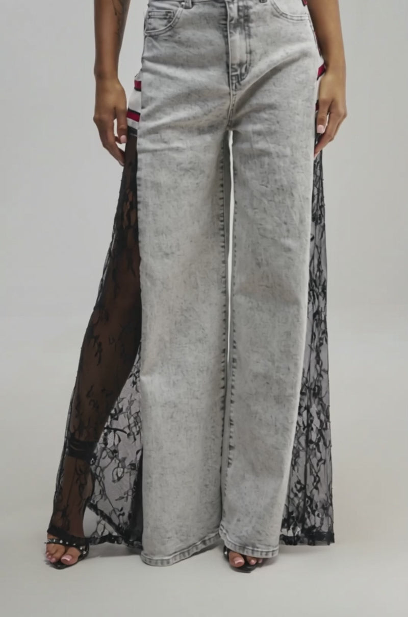 Video of a woman modeling the VARSITY SQUAD RELAXED DENIM jeans featuring lace panels.