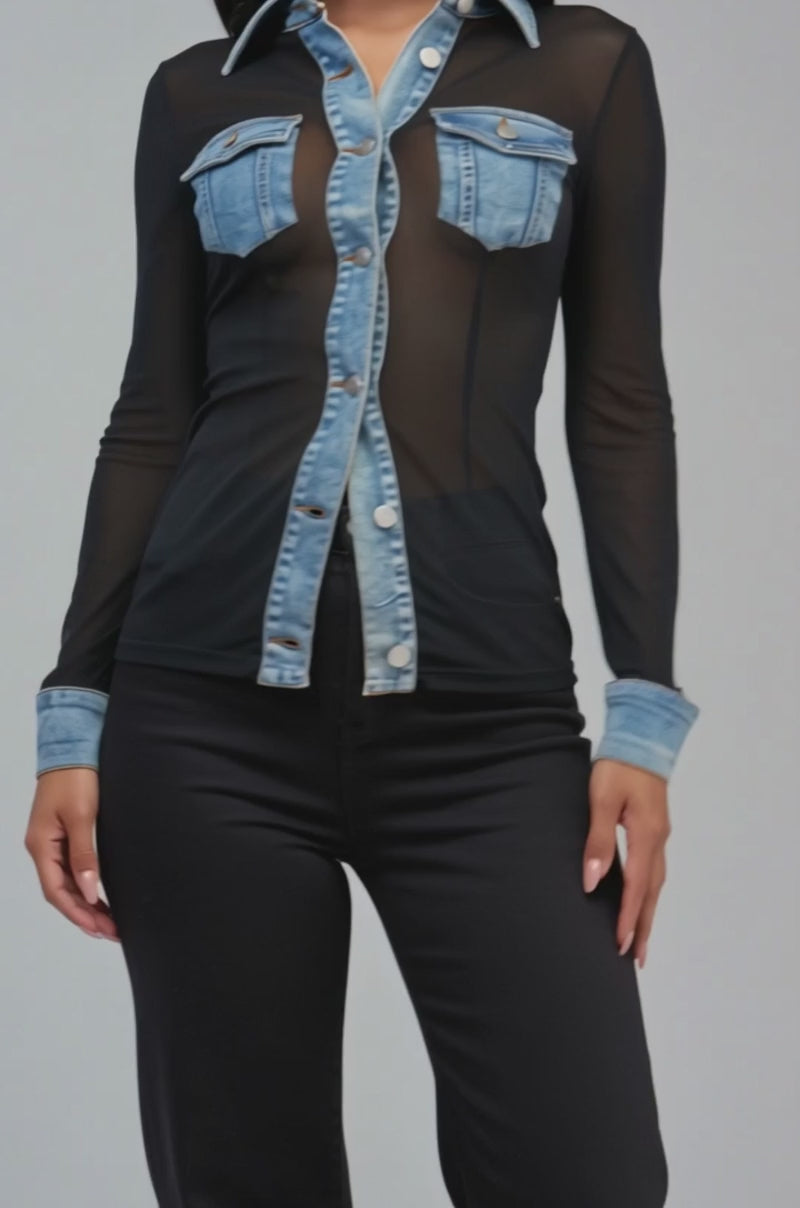 Video of a woman modeling the CAMILLA MESH BUTTON DOWN—a sheer black mesh top featuring denim trim on the collar, cuffs, and pockets.