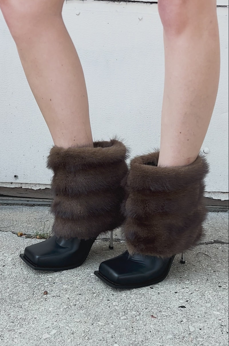 Video of person wearing AZALEA WANG CHINMAYI BROWN FUR CUFF SQUARE TOE STILETTO BOOTIES, featuring large brown fur cuffs.