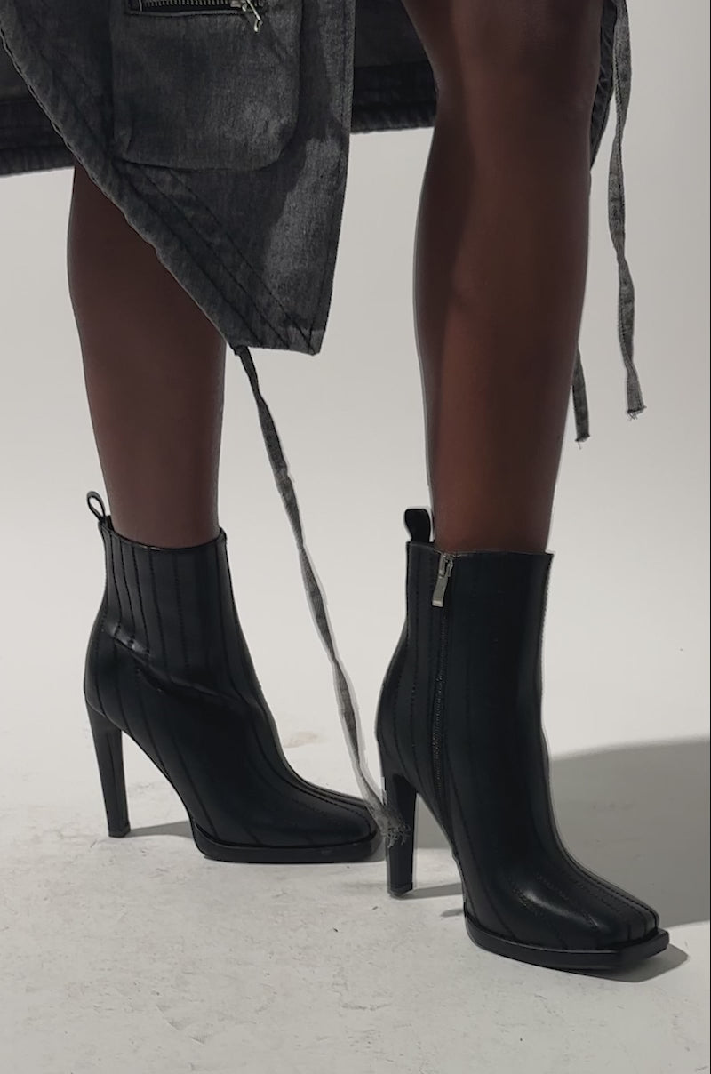 A video of a model wearing the AZALEA WANG AMHERST BLACK PU BOOTIE.